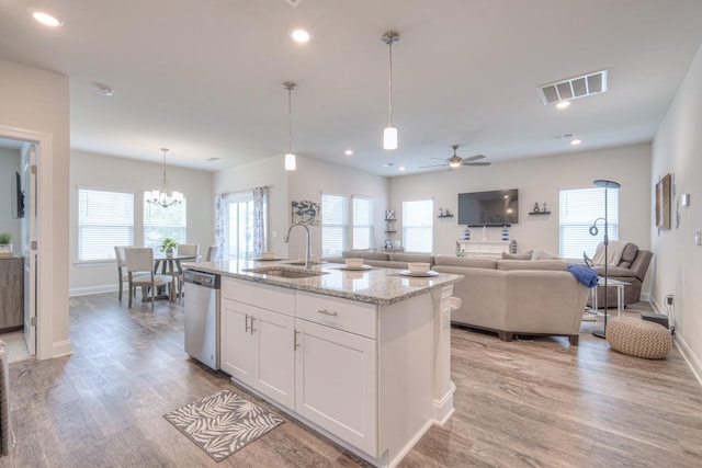 kitchen with visible vents, white cabinetry, a sink, light wood-style flooring, and dishwasher