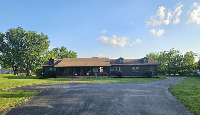 single story home with covered porch and a front lawn