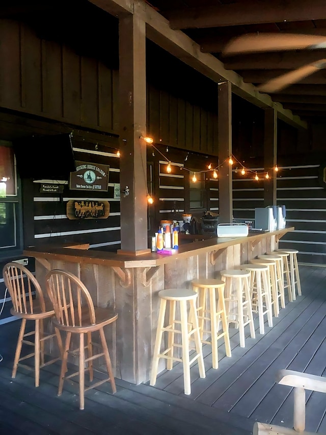 bar featuring a bar and wood finished floors