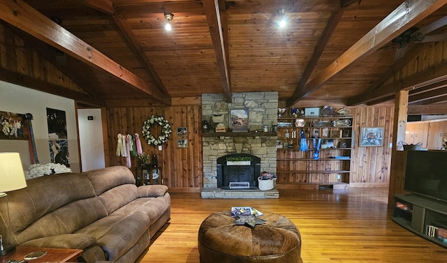 living area with wooden ceiling, wooden walls, vaulted ceiling with beams, and wood finished floors
