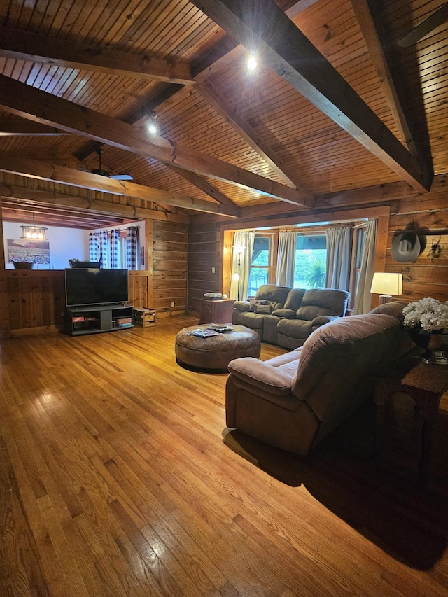 living area with wood ceiling, wooden walls, hardwood / wood-style floors, and vaulted ceiling with beams