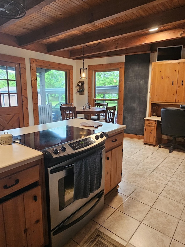 kitchen with light countertops, stainless steel electric range oven, and a healthy amount of sunlight