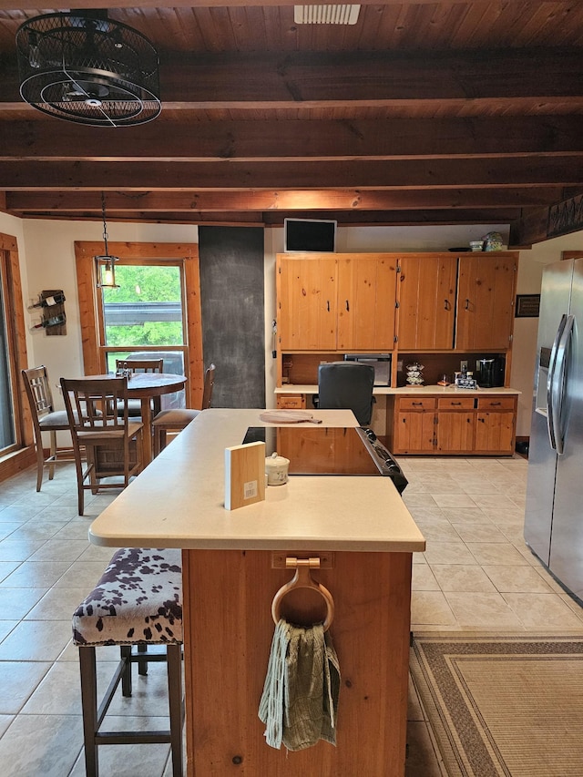 kitchen featuring wooden ceiling, light tile patterned flooring, stainless steel fridge with ice dispenser, beamed ceiling, and light countertops