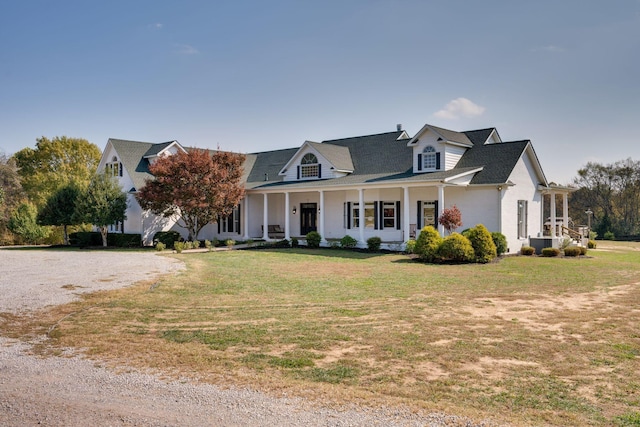 cape cod house featuring a porch and a front yard