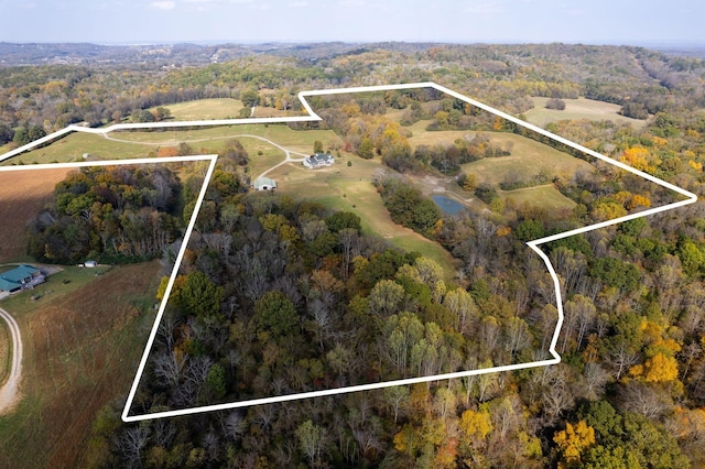 birds eye view of property featuring a wooded view