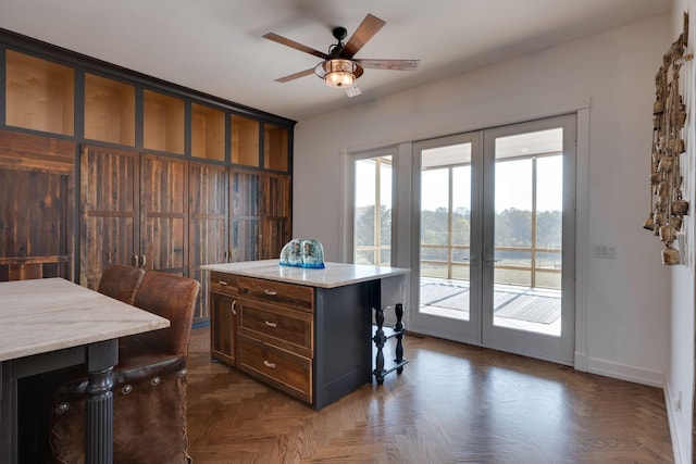 office featuring french doors, a ceiling fan, and baseboards