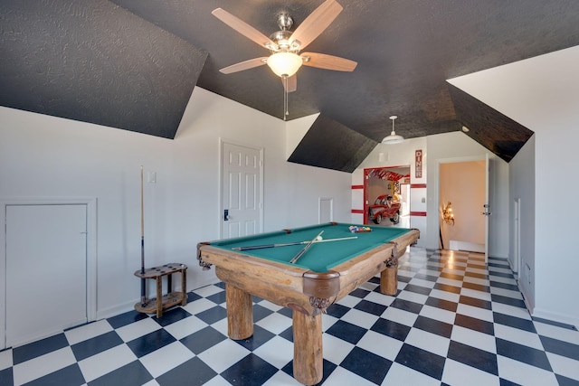rec room with a ceiling fan, tile patterned floors, and vaulted ceiling