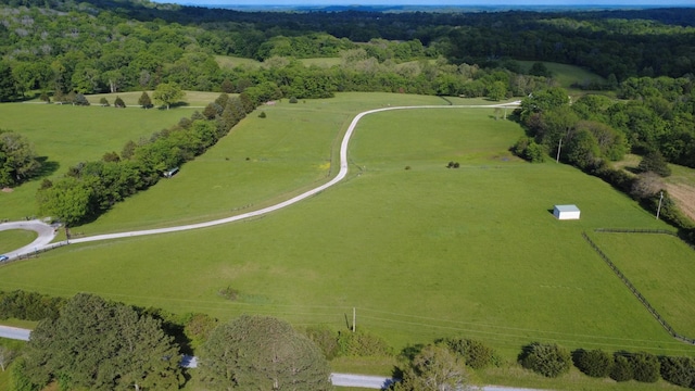 birds eye view of property featuring a rural view and a forest view