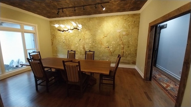 dining area featuring crown molding, baseboards, wood finished floors, and an ornate ceiling