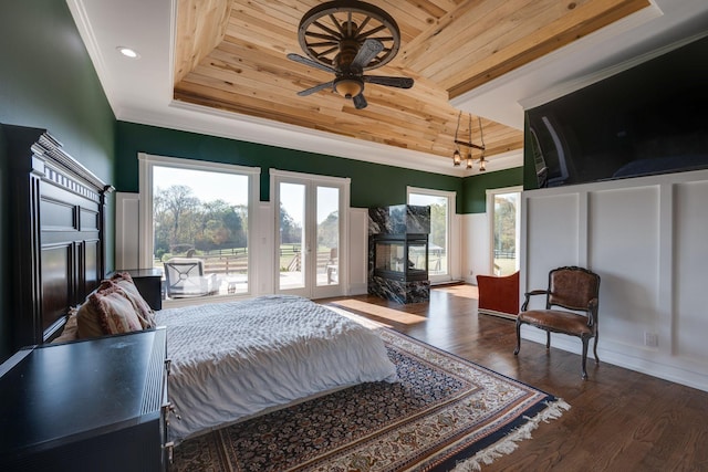 bedroom featuring crown molding, access to outside, french doors, wooden ceiling, and a tray ceiling