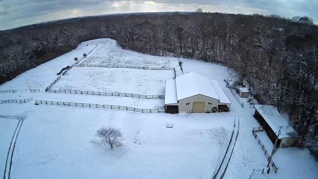 snowy aerial view with a view of trees