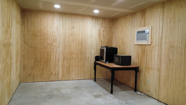 office with recessed lighting, concrete flooring, and wood walls