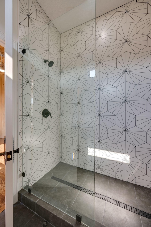 full bathroom with tile patterned floors and tiled shower
