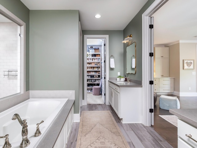 2025 Hornsby Dr, Franklin, TN 37064 - bathroom with a garden tub, wood finished floors, vanity, baseboards, and recessed lighting