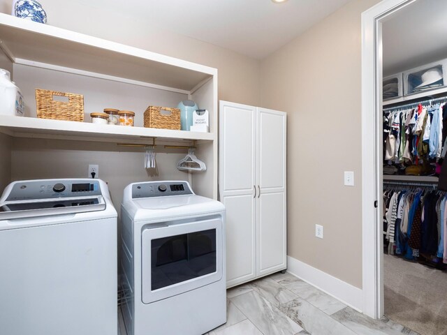 2025 Hornsby Dr, Franklin, TN 37064 - washroom with baseboards, marble finish floor, cabinet space, and washing machine and clothes dryer