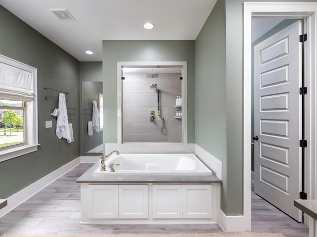 2025 Hornsby Dr, Franklin, TN 37064 - bathroom with a garden tub, visible vents, a tile shower, wood finished floors, and baseboards
