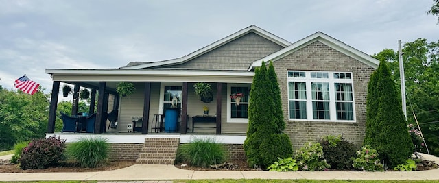 view of front of property with a porch and brick siding