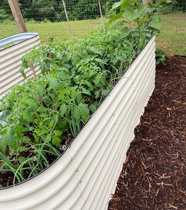 exterior details featuring a vegetable garden and fence