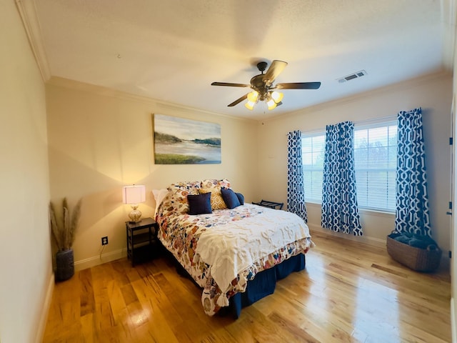 bedroom with ornamental molding, baseboards, and visible vents