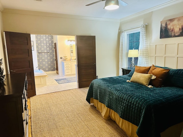 bedroom featuring a ceiling fan, ornamental molding, and wainscoting