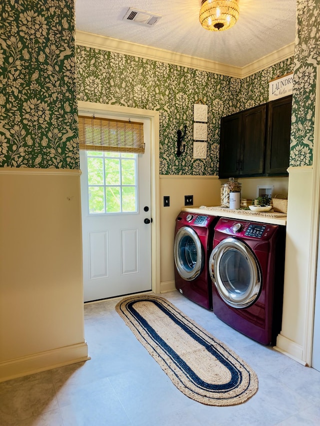 laundry room with cabinet space, wallpapered walls, visible vents, and crown molding