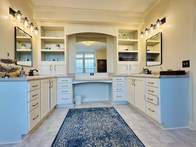 bathroom featuring two vanities, a sink, crown molding, and built in features