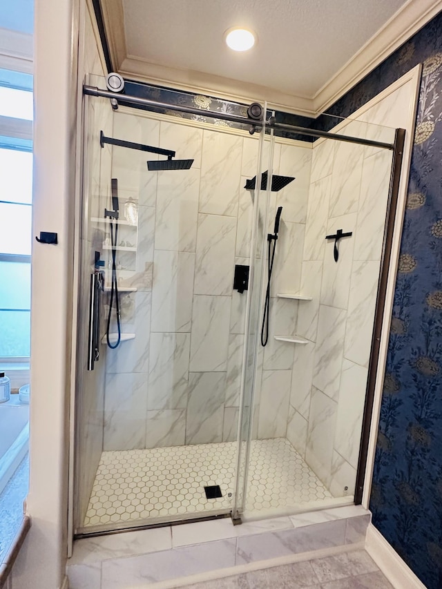 bathroom with a stall shower, crown molding, baseboards, and marble finish floor