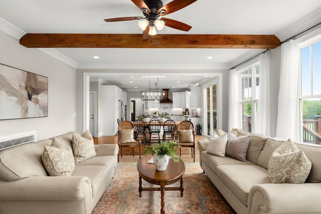 living area with ceiling fan with notable chandelier, recessed lighting, beam ceiling, and visible vents