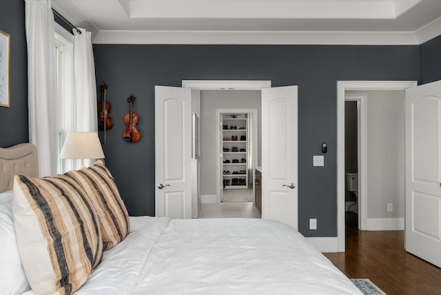bedroom featuring baseboards and wood finished floors