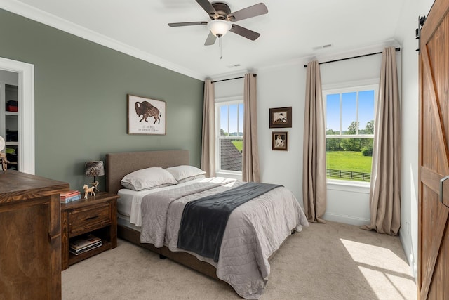 bedroom with light colored carpet, a ceiling fan, baseboards, visible vents, and ornamental molding