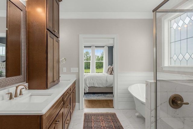 full bathroom featuring double vanity, a sink, a wainscoted wall, marble finish floor, and a soaking tub