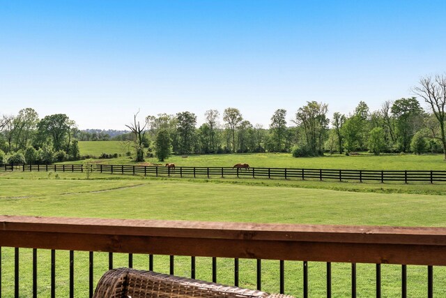 view of yard featuring a rural view and fence