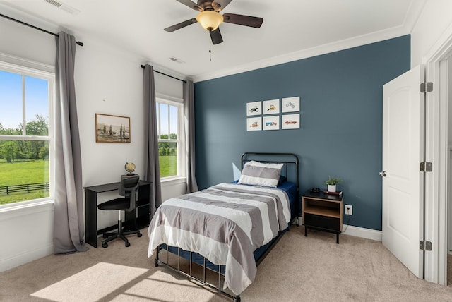 bedroom with visible vents, multiple windows, and light carpet