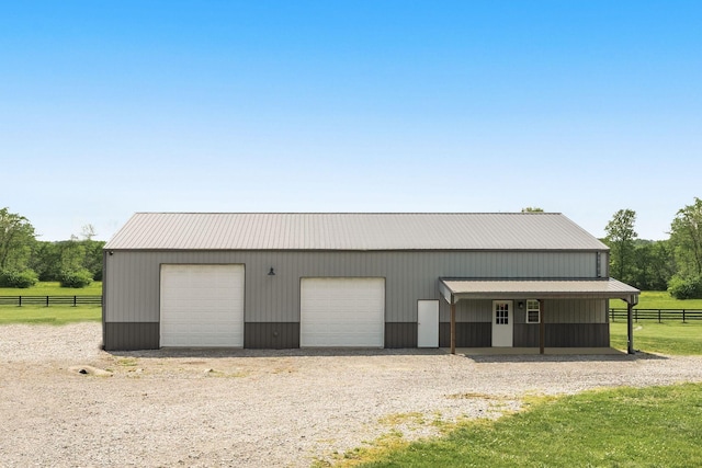 detached garage featuring fence