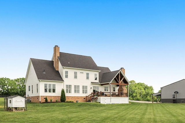 rear view of house with a yard, crawl space, a chimney, and a wooden deck