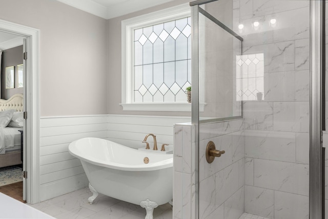 ensuite bathroom with a freestanding tub, ensuite bath, marble finish floor, and a stall shower