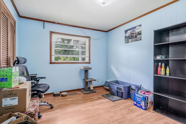 office space with crown molding, baseboards, and wood finished floors