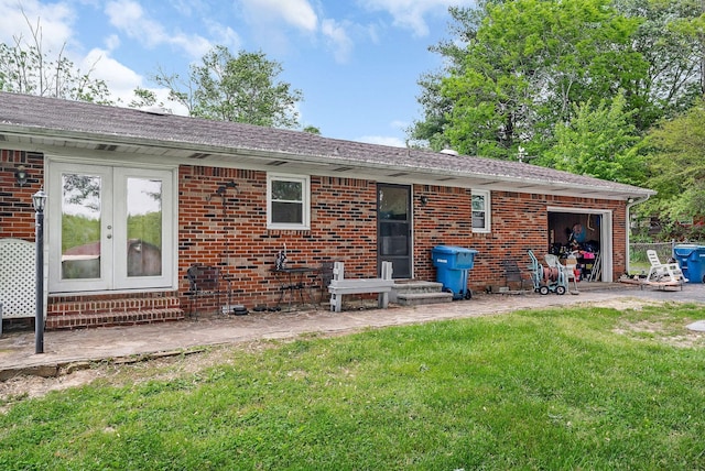 rear view of property with french doors, a yard, roof with shingles, and brick siding
