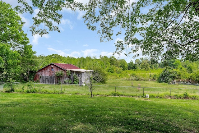 view of yard featuring fence and a forest view