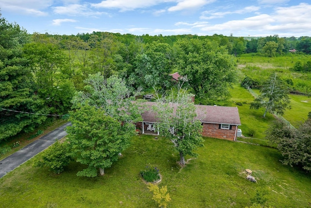 birds eye view of property with a view of trees