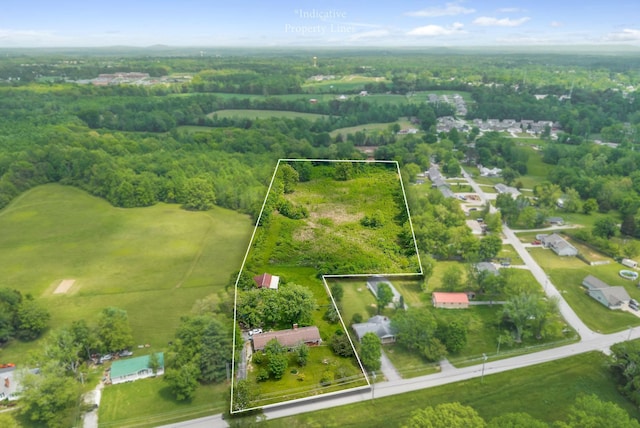 birds eye view of property featuring a wooded view