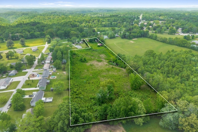 drone / aerial view with a wooded view