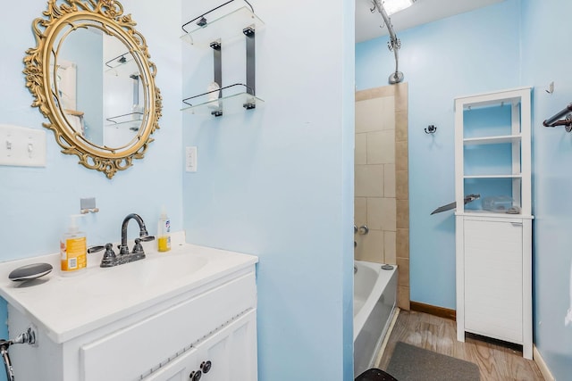 full bath with vanity, tub / shower combination, and wood finished floors