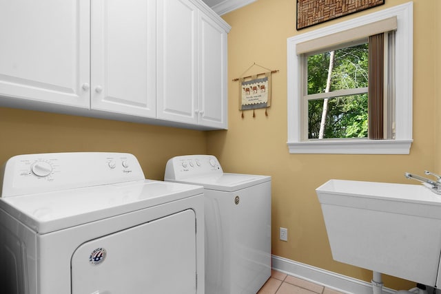 7237 River Run Dr, Chattanooga, TN 37416 - washroom featuring cabinet space, light tile patterned flooring, a sink, baseboards, and washer and clothes dryer