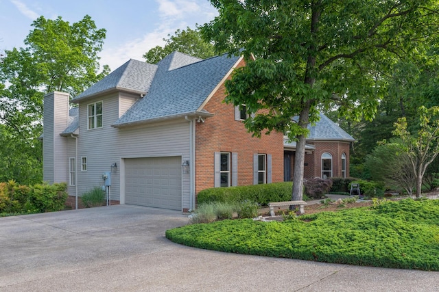 7237 River Run Dr, Chattanooga, TN 37416 - traditional home with an attached garage, roof with shingles, driveway, and brick siding