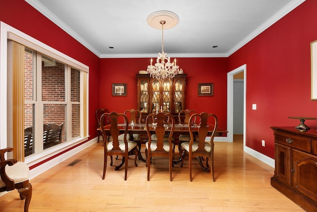7237 River Run Dr, Chattanooga, TN 37416 - dining area with crown molding, baseboards, a notable chandelier, and light wood-type flooring