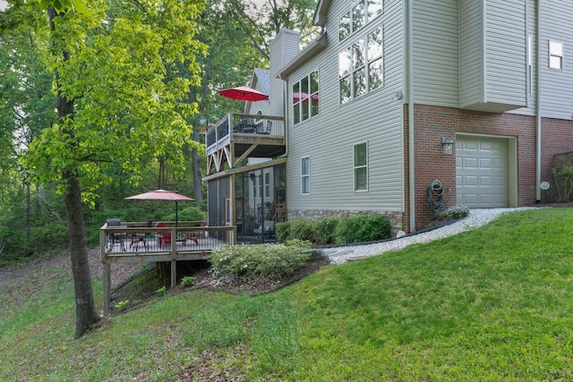 7237 River Run Dr, Chattanooga, TN 37416 - view of home's exterior featuring a lawn, a wooden deck, a sunroom, a garage, and brick siding