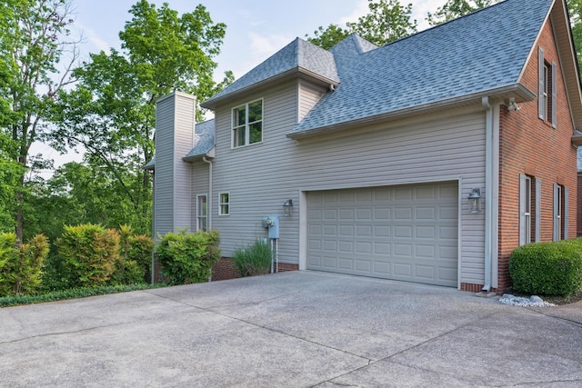 7237 River Run Dr, Chattanooga, TN 37416 - view of side of property featuring a garage, roof with shingles, driveway, and a chimney