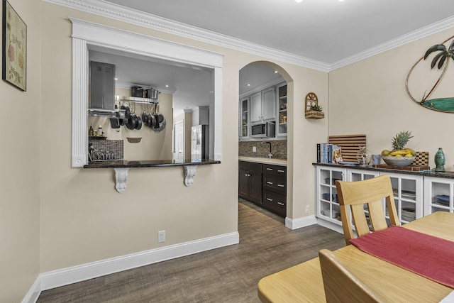 120 Tanasi Shr, Gallatin, TN 37066 - dining space featuring arched walkways, baseboards, ornamental molding, and dark wood-type flooring