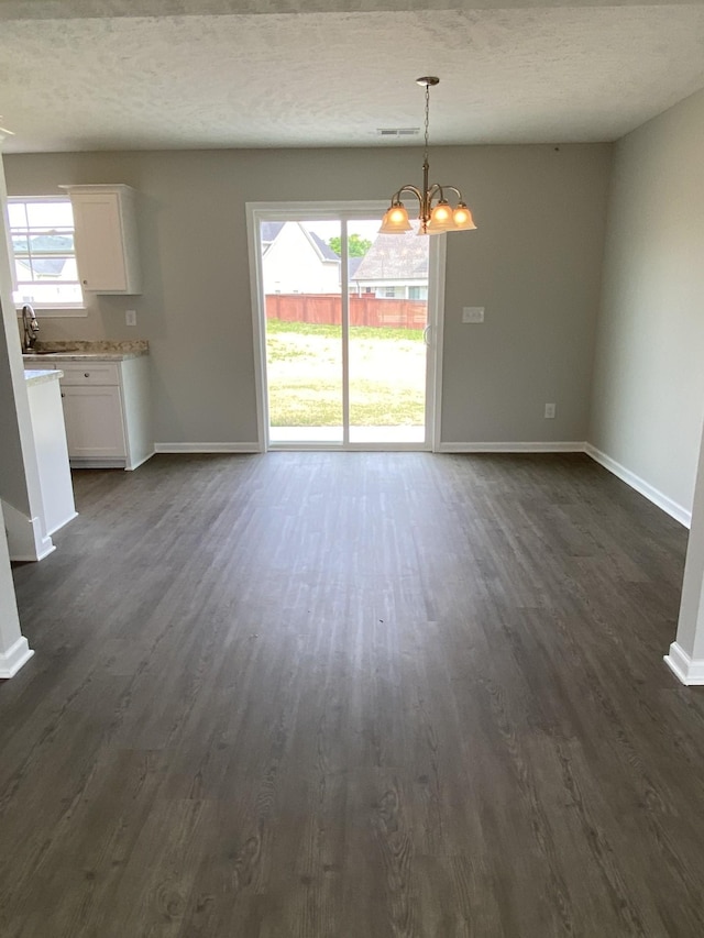 1110 Merritt Hill Trl, Smyrna, TN 37167 - unfurnished dining area featuring a healthy amount of sunlight, baseboards, dark wood finished floors, and a chandelier